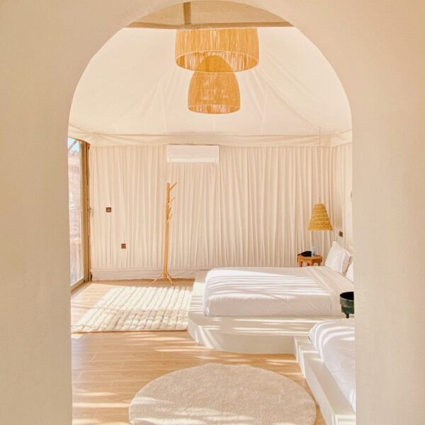 a bedroom with two beds and a rug on the floor