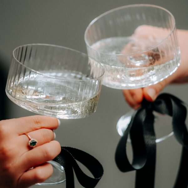 A couple of people holding wine glasses in their hands